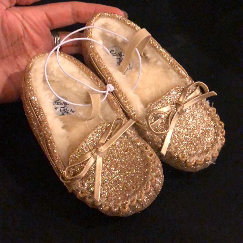 NWT. Moccasins size 7 toddler. Gold and iridescent glitter. No box